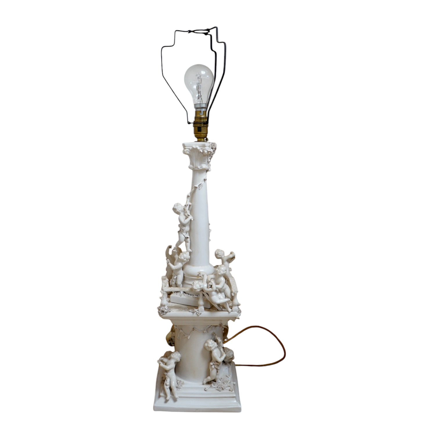 A modern Italian white maiolica ‘playing putti’ table lamp, 55cm. Condition - fair